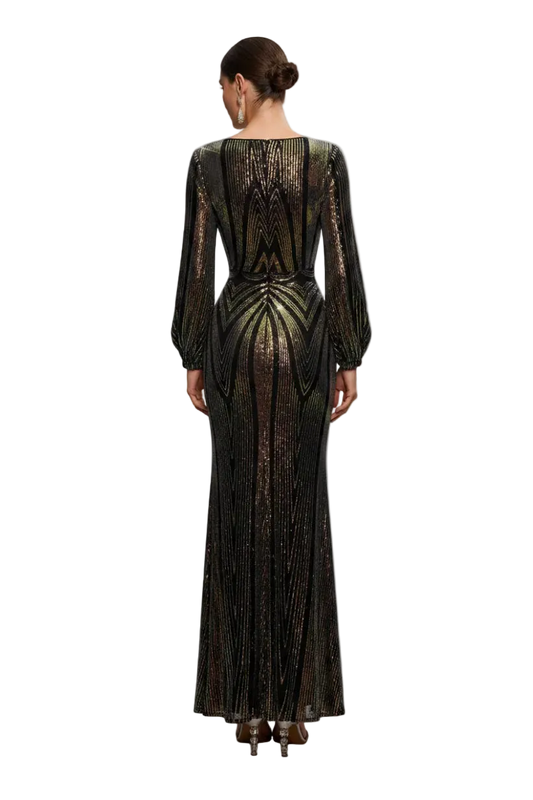 Woman wearing a black and gold sequin dress in a softly lit room.