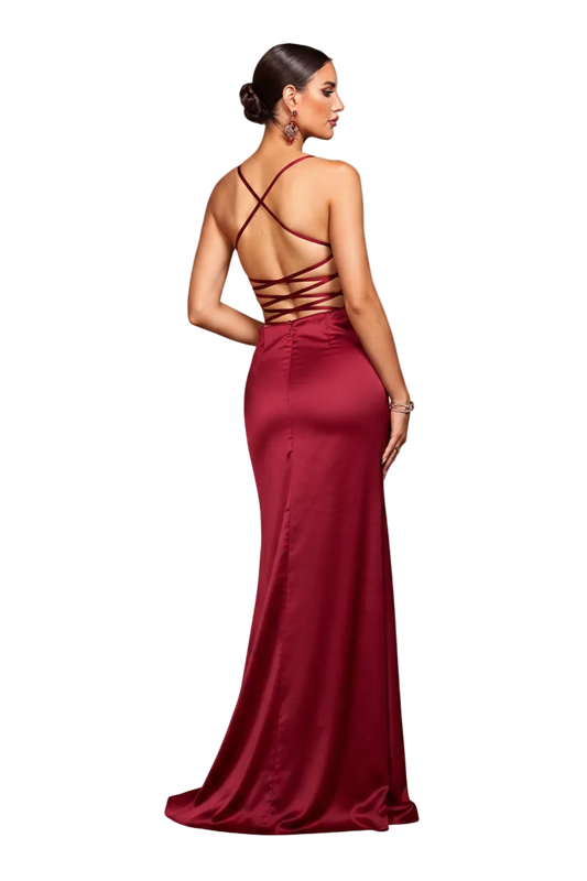 Woman wearing a red evening gown with a backless design in an elegant indoor setting.