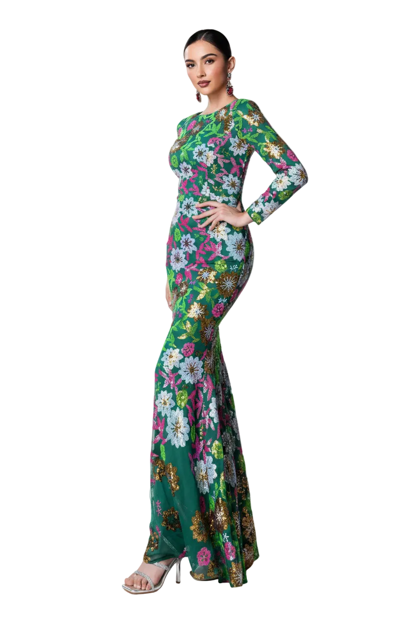 A woman modeling a long-sleeve, floor-length green mermaid-style gown with a colorful floral print, posed against a solid black background.