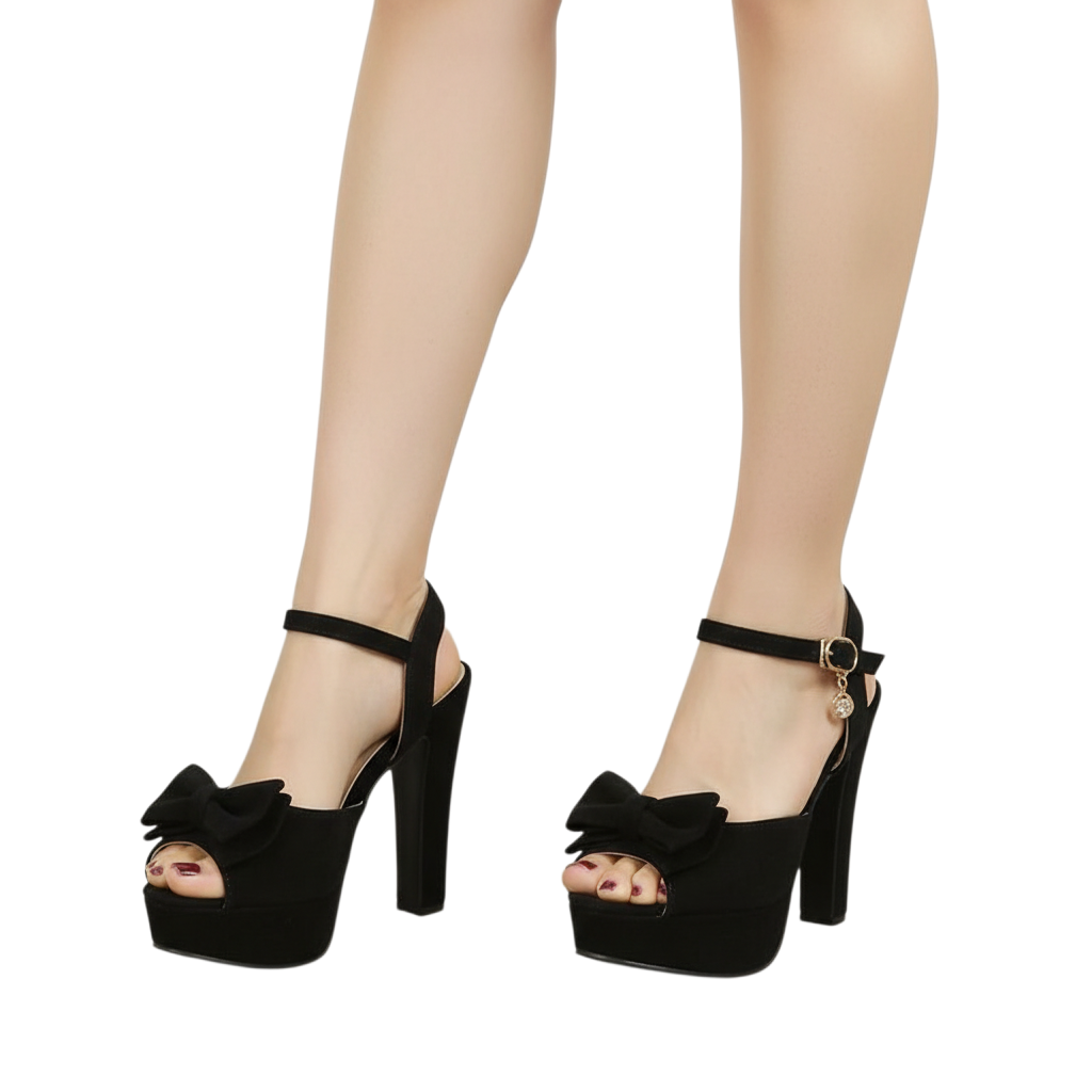 JASE Heart black velvet platform high heels with a decorative bow and ankle strap on a model