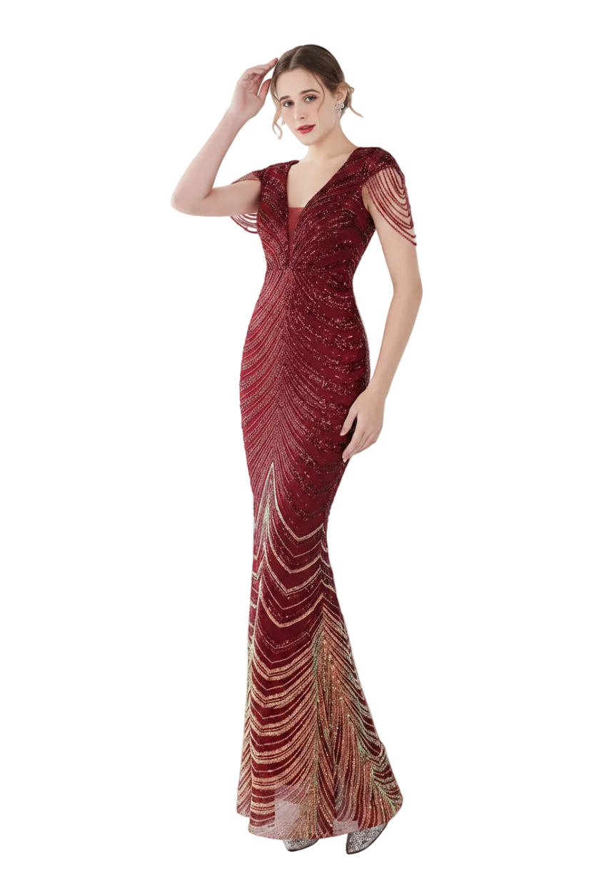 Woman in a red evening gown standing in front of a mirror in a white room.