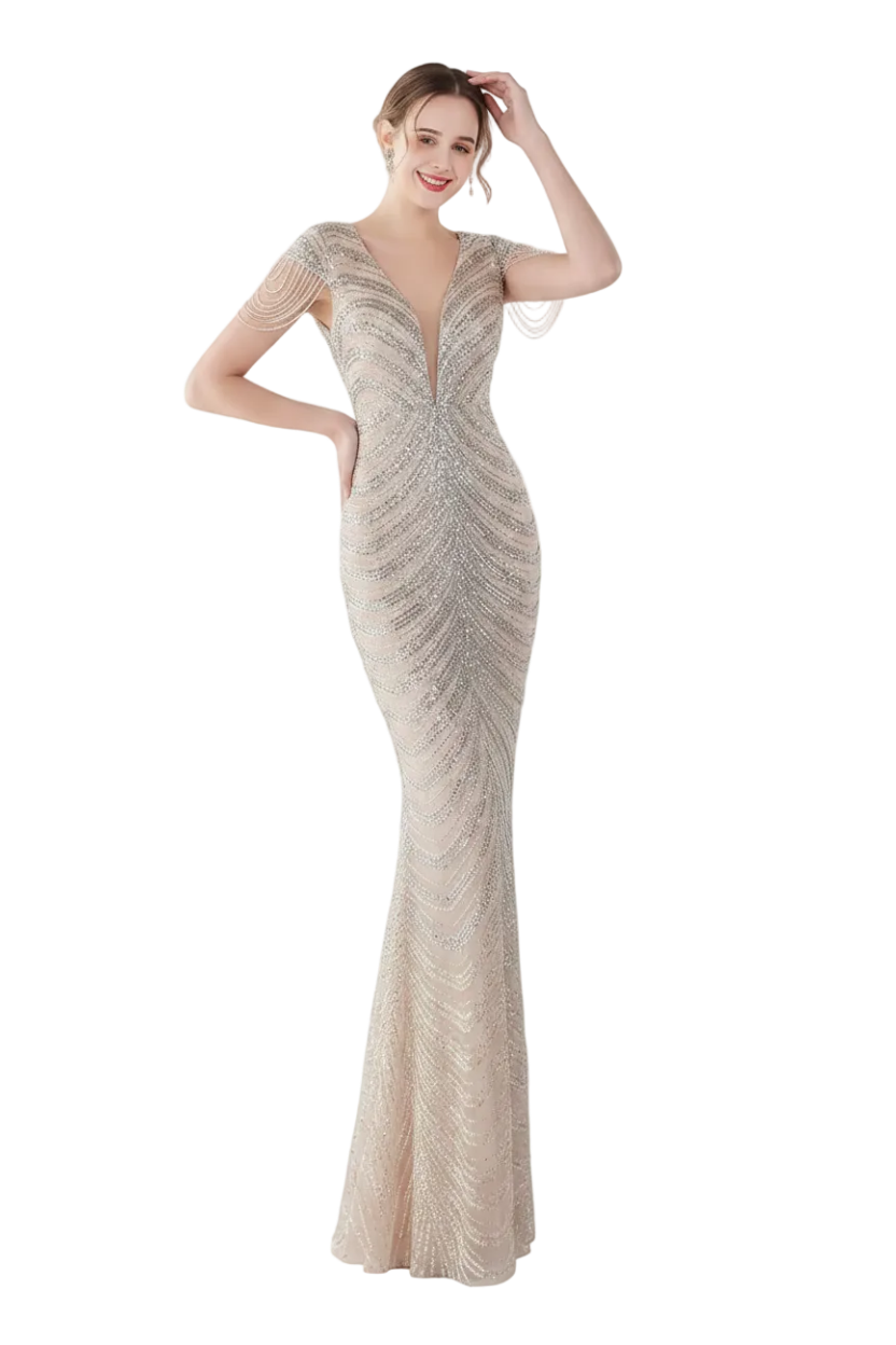 Woman wearing a sparkling evening gown in a white room with a mirror.