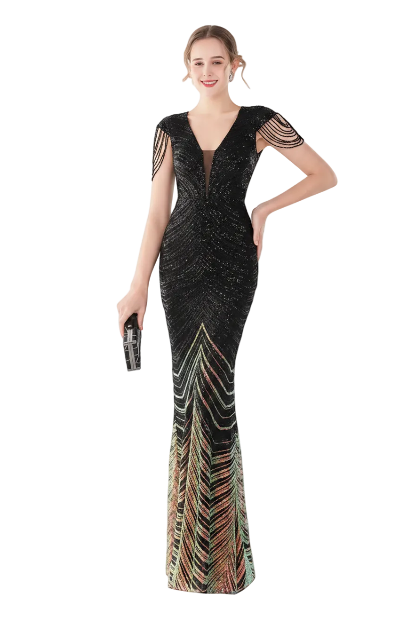 Woman wearing a black evening gown with colorful patterns, standing in front of a mirror.