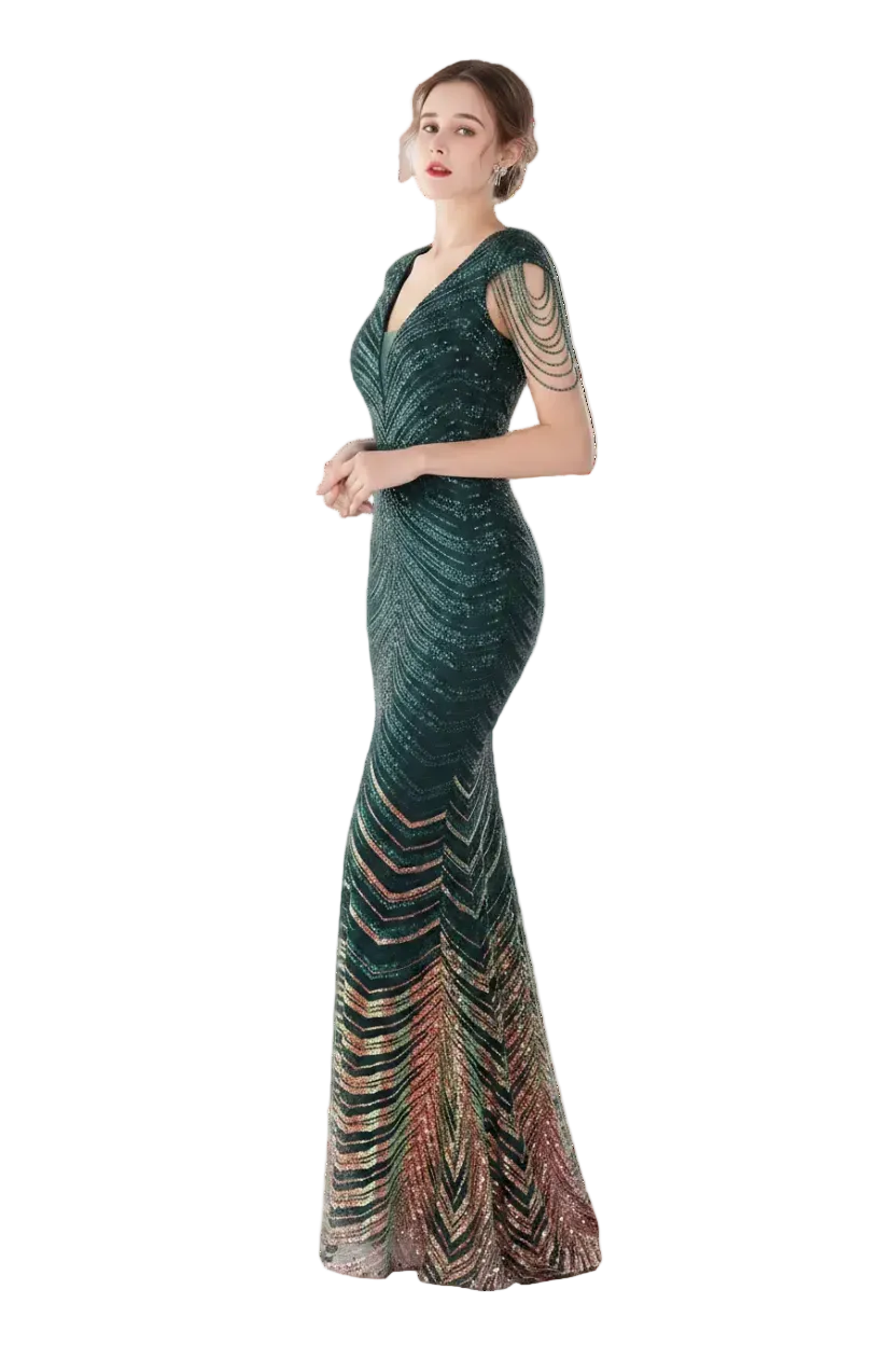 Woman in a green evening gown standing in front of a mirror.