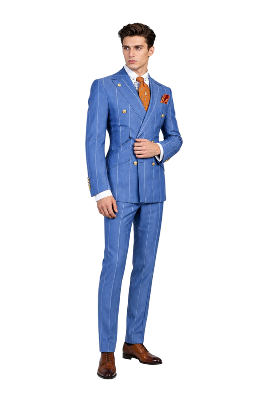 A man wearing a blue double-breasted pinstripe suit with gold buttons, a white shirt, and an orange patterned tie, standing against a textured light gray background. The UA logo is visible in the top left corner.