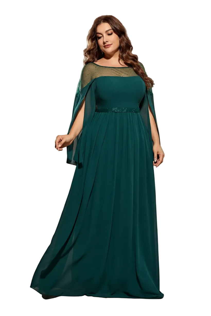 Woman wearing a long teal dress with a cape against a neutral background