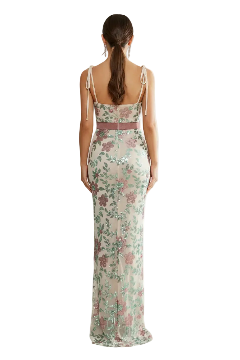Woman wearing a floral dress with a brand logo in the corner