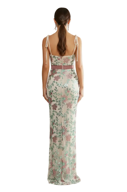 Woman wearing a floral dress with a brand logo in the corner