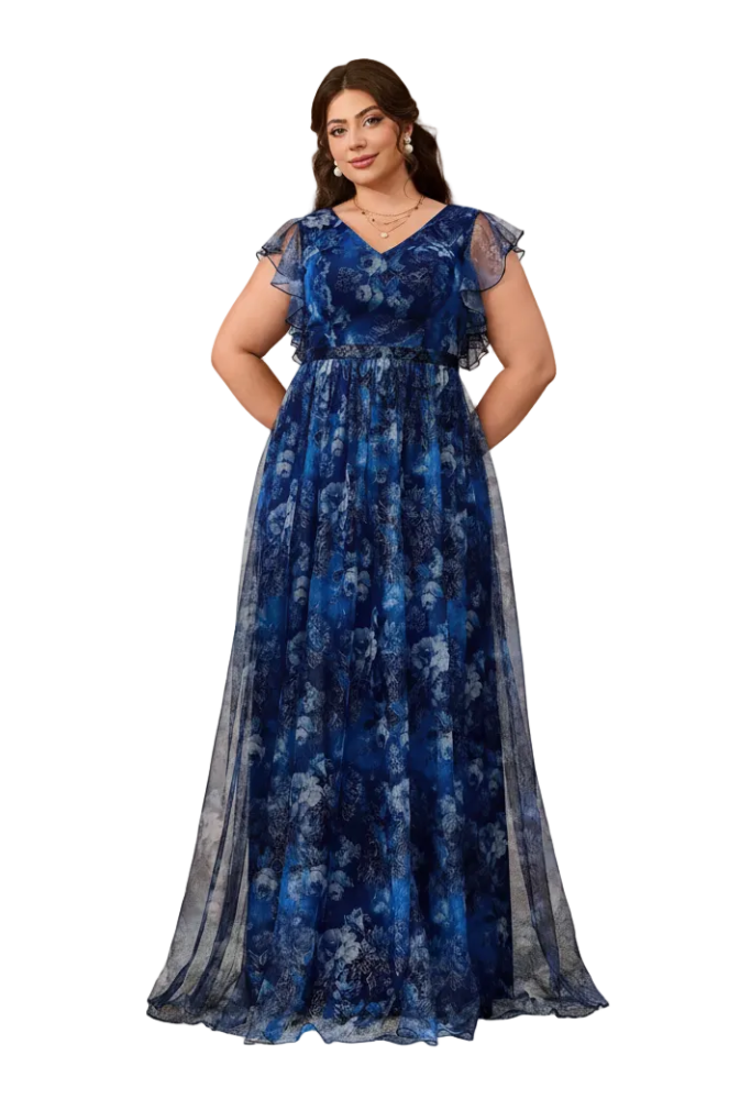 A woman modeling a floor-length blue floral gown with sheer flutter sleeves and a V-neckline, standing against a warm beige arched backdrop.