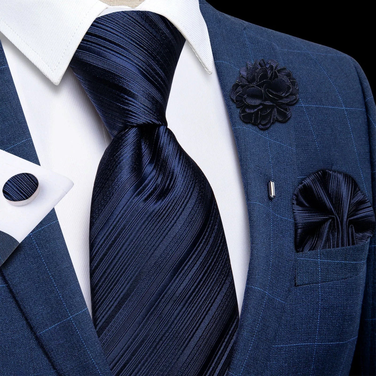 JASE HEART GLOBAL navy blue striped silk necktie set with matching pocket square, lapel flower, and cufflinks on a suit