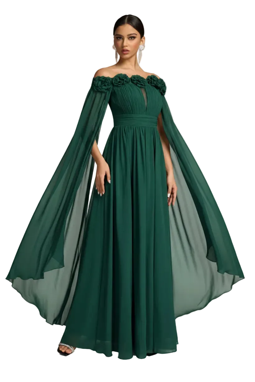 A woman modeling a floor-length off-the-shoulder gown in deep emerald green. The dress features a structured bodice with floral applique at the shoulders, a fitted waist, and a flowing sheer cape-like overlay that extends from the shoulders.
