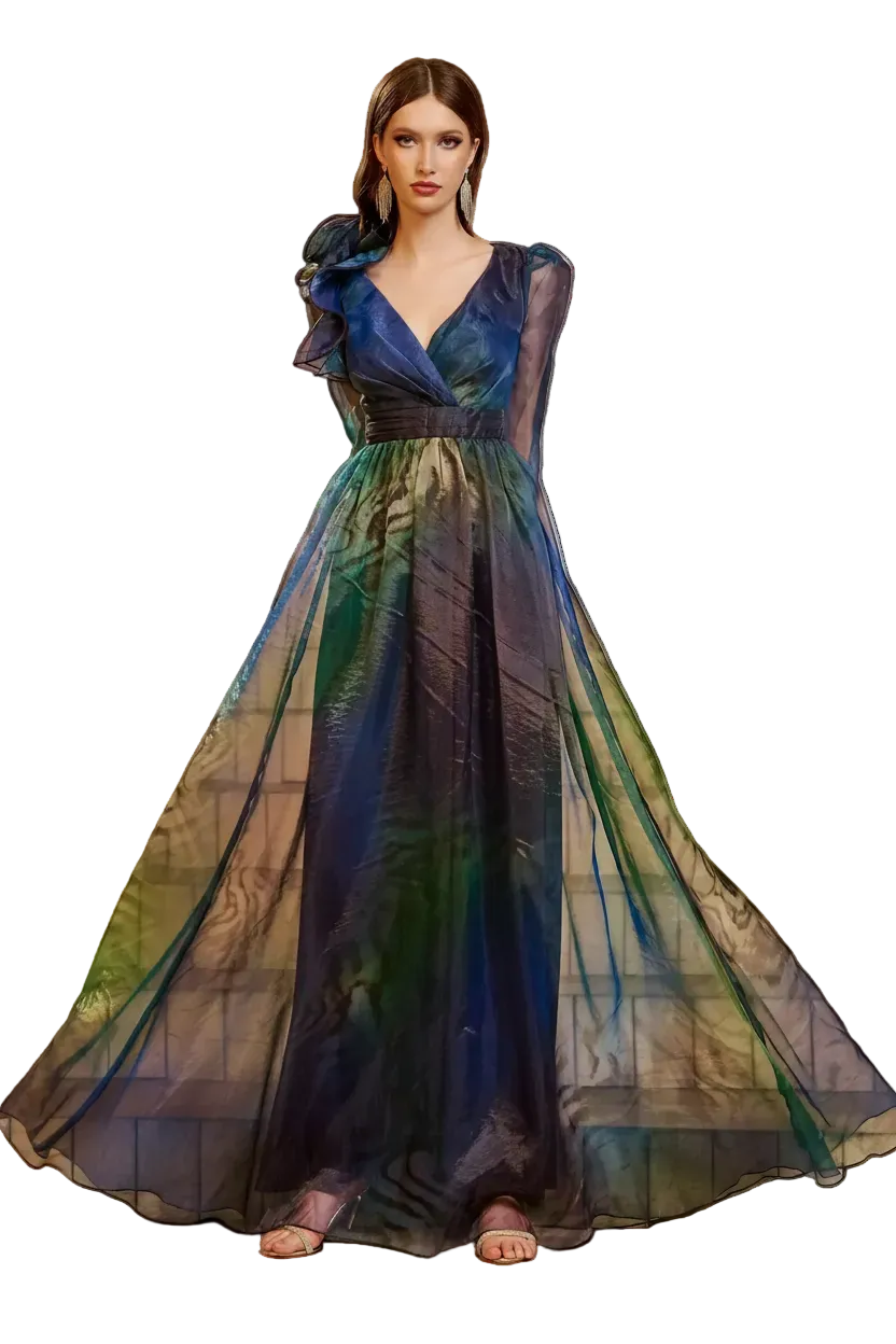 A woman stands on stone stairs wearing a floor-length formal gown with sheer layered fabric and a gradient color story shifting from deep navy and blue at the top to green and teal lower down. The dress has ruffled sleeves and a V-neckline.