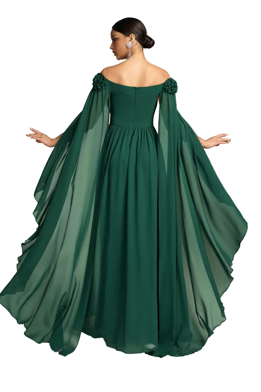 A woman modeling an off-the-shoulder floor-length gown in dark emerald green, shown from the back. The dress features a fitted bodice, a full skirt, and dramatic flowing cape-like sleeves with floral details at the shoulders, set against a plain white background.