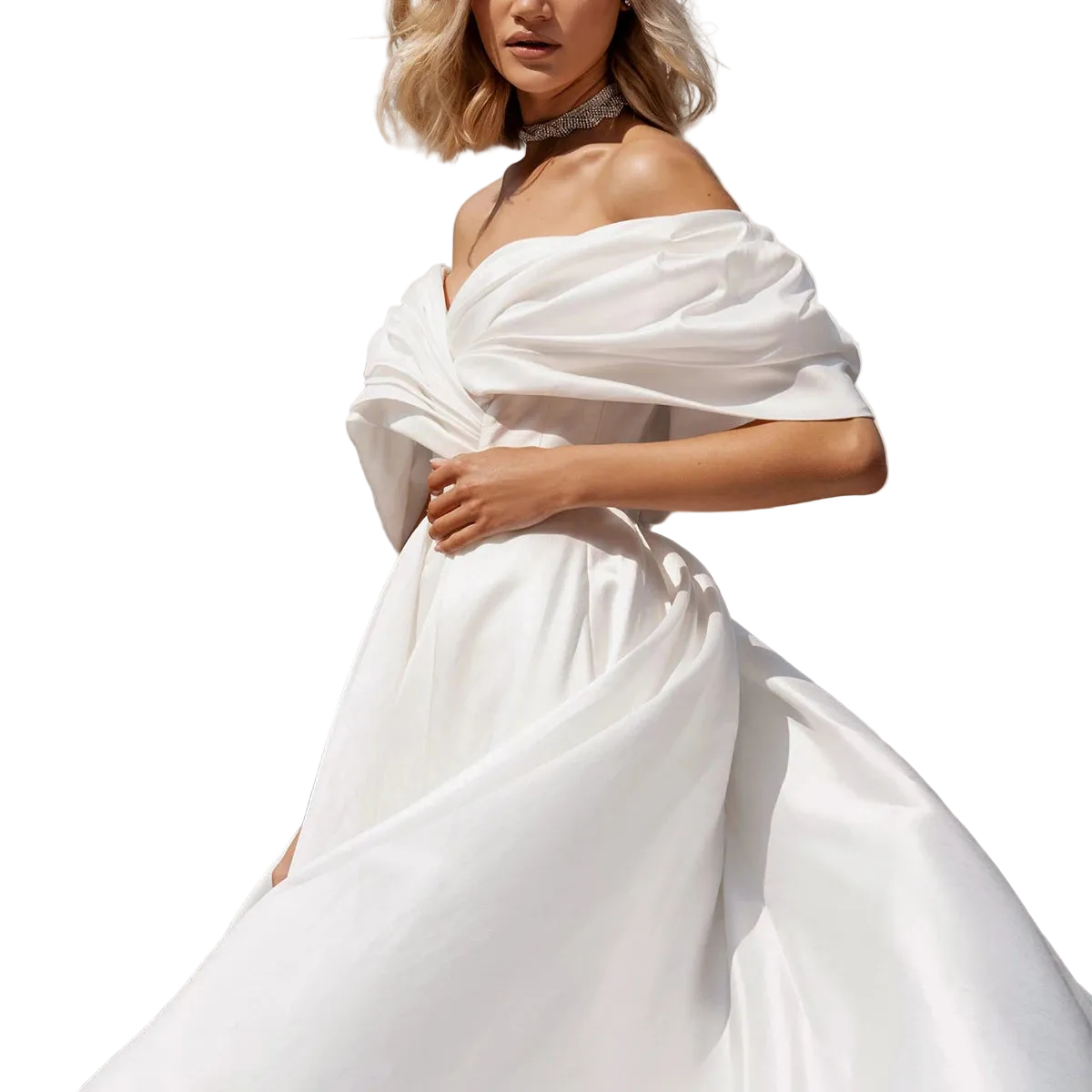 A woman wearing an off-the-shoulder white gown with a voluminous skirt and draped fabric details, shown against a plain white background.