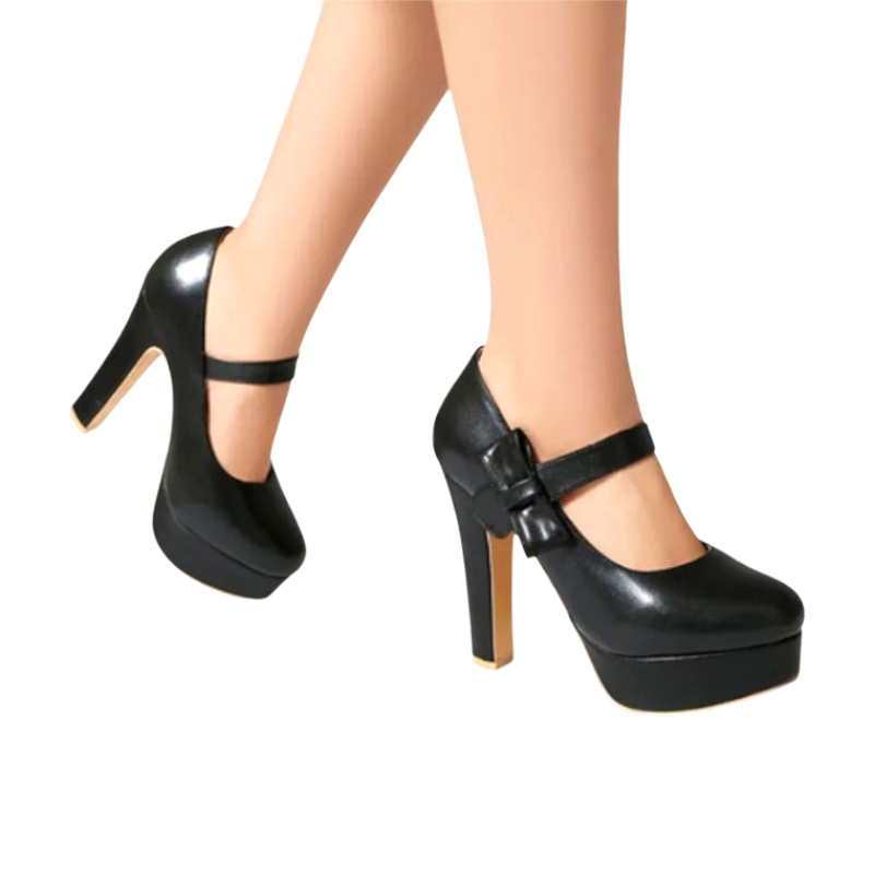 JASE Heart black platform Mary Jane heels with a bow detail and block heel worn on feet