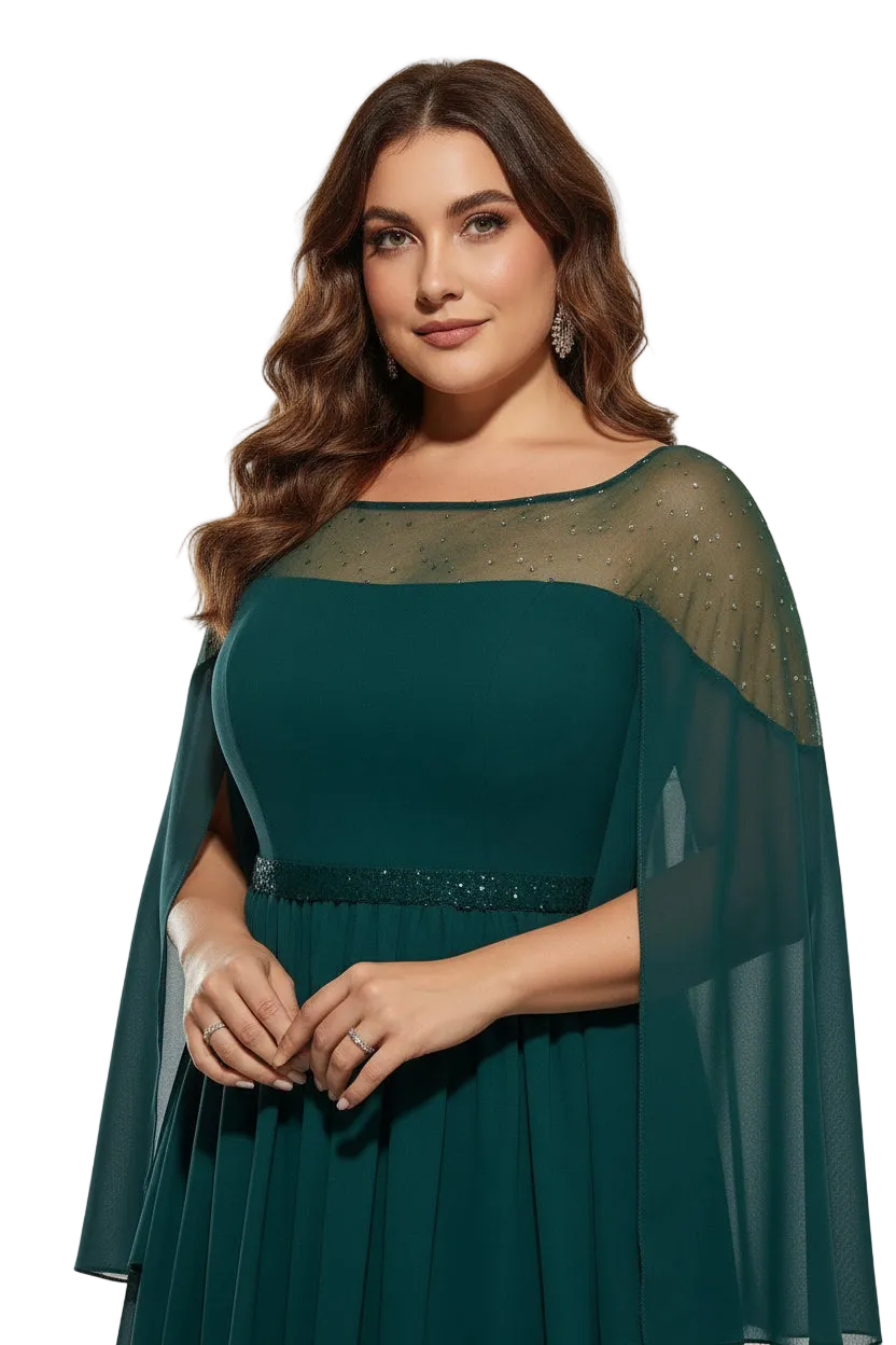 Woman wearing a teal dress with a sheer cape against a neutral background