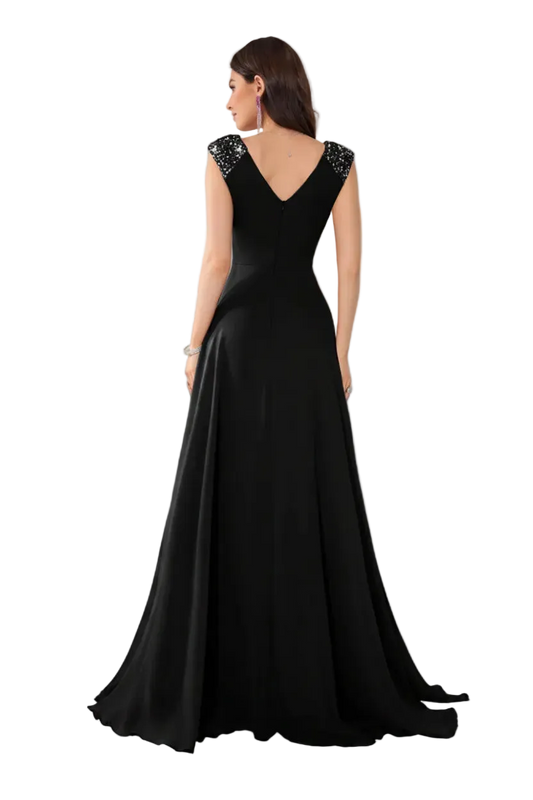 Black evening gown with beaded straps on a white background