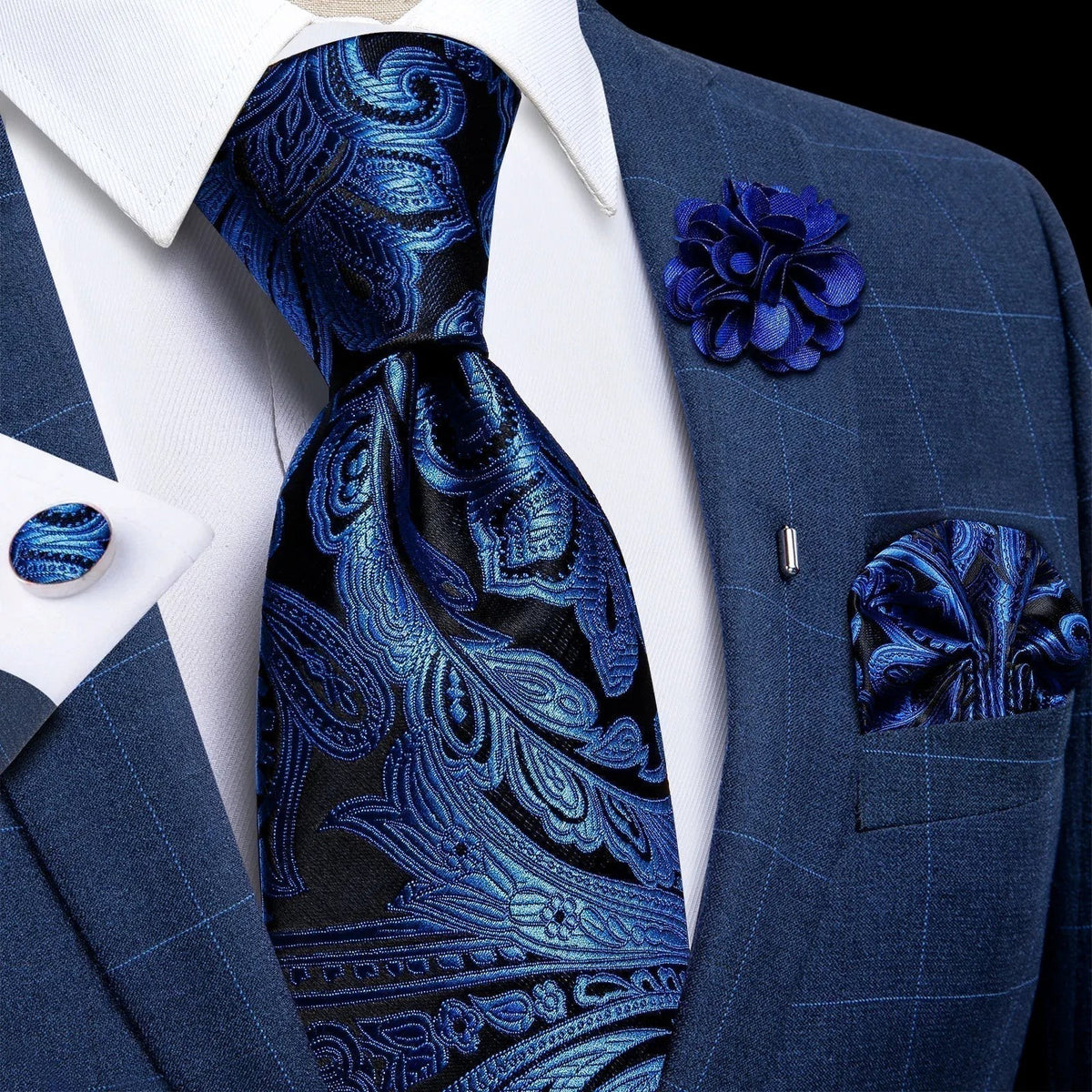 JASE HEART GLOBAL blue and black paisley silk necktie set with matching pocket square, lapel flower, and cufflinks.