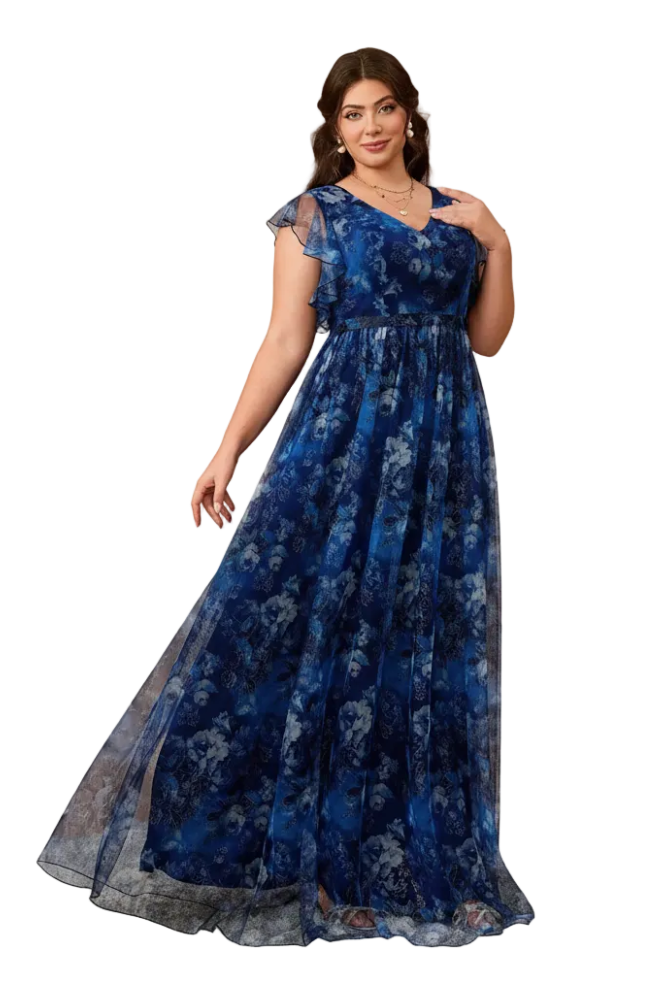 A woman modeling a floor-length blue floral dress with sheer cap sleeves and a V-neckline, standing against a warm beige arched backdrop.