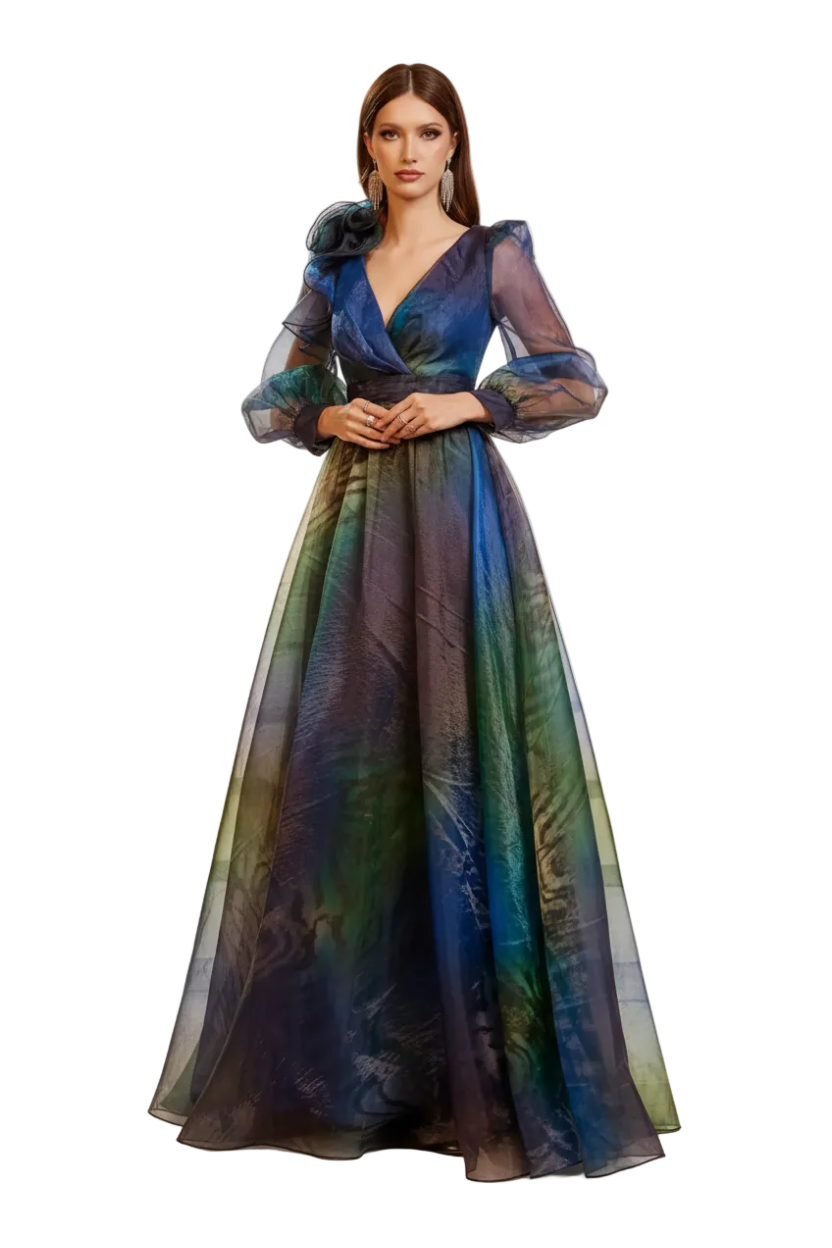 A woman stands on stone stairs wearing a floor-length sheer gown with a deep V-neck, ruffled long sleeves, and an iridescent blue-green-purple color-shifting fabric. The Miss Ord logo appears in the top-left corner.