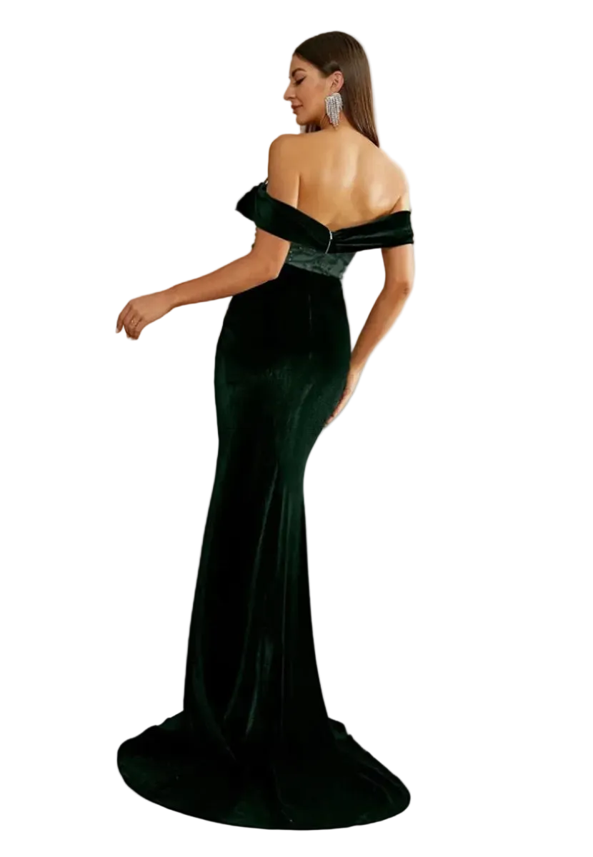 Woman wearing a dark green off-shoulder evening gown in a room with large windows.