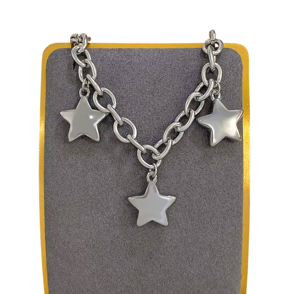 JASE HEART GLOBAL silver chain necklace featuring three polished star charms on a grey display stand