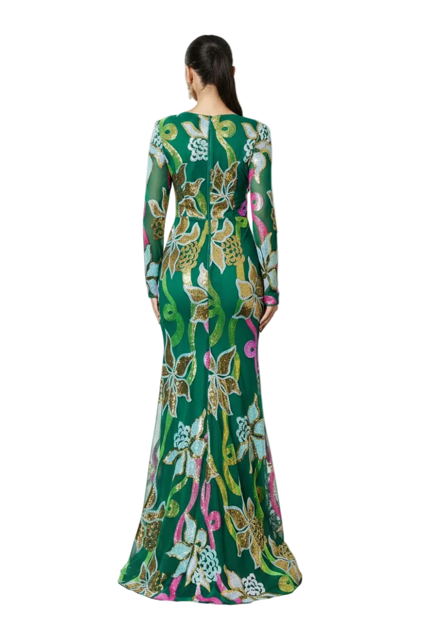Woman wearing a long, floral-patterned dress against a blue background with 'Miss QED' branding.